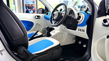 luxury vehicle, blue and white interior, modern car, advanced technology, sleek design, car interior, smart car, stylish vehicle, blue seats, white dashboard, black steering wheel