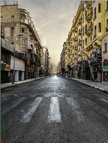 black asphalt road, brown city buildings, white skies, daytime, deserted urban street, classic buildings, warm sky, cityscape, street view, urban landscape, architecture