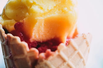 ice cream cone, vibrant ice cream, multiple flavors, close-up ice cream, waffle cone, tempting ice cream, colorful ice cream, dessert, frozen treat, summer snack, sweet treat