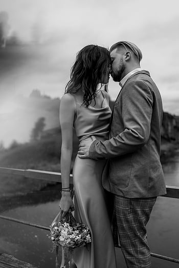 black and white wedding, young couple, kissing, intimate portrait, bridge, outdoors, black and white photo, couple in love, romantic scene, wedding couple, black and white photography