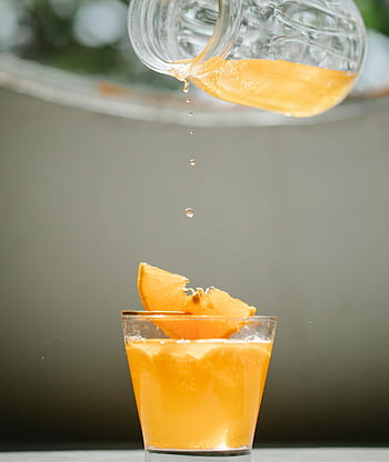 orange juice, glass jug, pouring juice, fresh citrus slices, vibrant orange, glass filled, citrus juice, drink preparation, healthy beverage, refreshing drink, citrus fruit