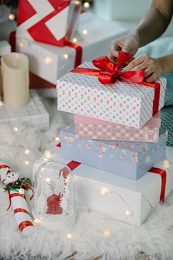 Weihnachtsgeschenkverpackung, Feiertagsdekorationen, rote Bänder, Wunderschön verpackte Geschenke, Weihnachtsgeschenke, Geschenkbox, Festliche Lichter, Feiertagsfeierlichkeiten, Weihnachtsvorbereitung, Geschenk Dekoration, Weihnachtsszene