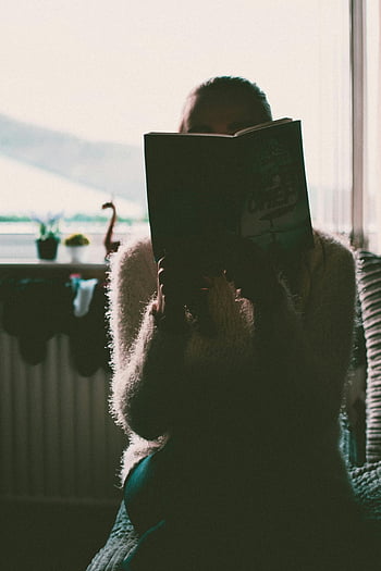 kvinna läser bok, silhuett, inomhus, soligt fönster, bok, läsning, inomhusscen, naturligt ljus, mysig atmosfär, tillfällig läsning, heminställning