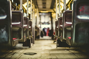 public transport, train seats, interior view, empty vehicle, rows of seats, warm lighting, grey metal, public transportation, train interior, empty train, metal seats