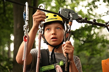 boy, silver harness, rope climbing, outdoor activity, helmet, safety gear, young boy, climbing activity, outdoor fun, adventure, zipline
