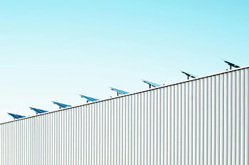solar panels, roof, corrugated steel, building, clear blue sky, sustainability, eco-friendly, renewable energy, solar power, green technology, energy efficiency