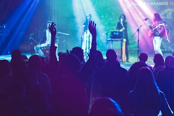 band performing, stage, concert scene, musicians, enthusiastic audience, live music, stage lighting, crowd, performance, event, nightlife