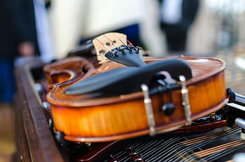 vintage violin, artistic close-up, wooden texture, intricate details, table, musical instrument, string instrument, classic violin, antique violin, violin photography, violin art