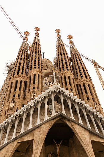 Sagrada Familia, Barcelona, Spain, intricate facade, spires, Antoni Gaudi, Gothic architecture, religious building, famous landmark, construction cranes, detailed sculptures