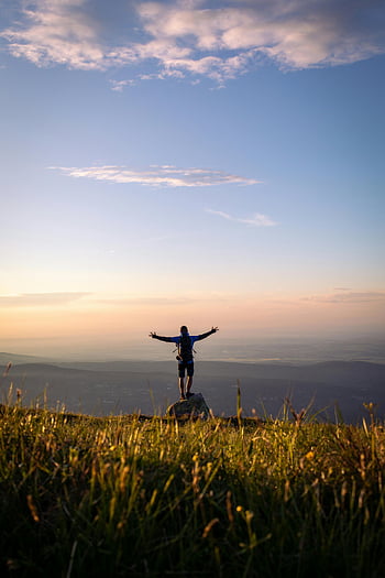 hiker, mountain peak, arms outstretched, vibrant sunset, Szklarska Poręba, Poland, silhouette, outdoor adventure, nature photography, travel photography, landscape photography