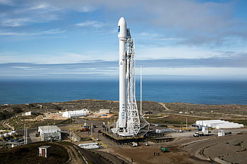 SpaceX rocket, launch pad, ocean view, clear sky, rocket launch, white rocket, SpaceX, launch site, coastal launch, rocket technology, space exploration