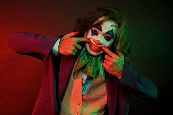 clown makeup, gloomy man, colorful costume, clown face, entertaining pose, clown costume, clown character, clown entertainment, clown performance, clown artistry, clown photography