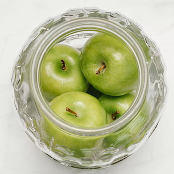green apples, glass bowl, top view, freshness, transparent glass, apple display, fruit bowl, healthy eating, kitchen decor, food photography, natural food
