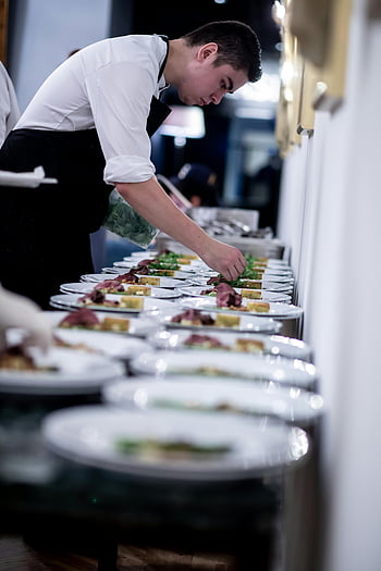 chef, preparing food, dinner, uniform, garnishing, gourmet dishes, table, indoors, food presentation, culinary arts, restaurant kitchen