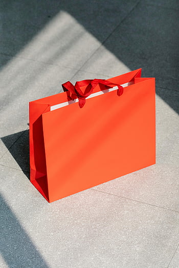 red shopping bag, tiled floor, sunlit shadows, retail, commerce, bright red, paper bag, floor, shopping, bag, shadows