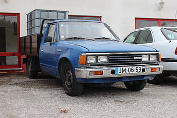 Nissan, 720, pickup, truck, blue, license plate, JM-06-53, parked, gravel, building, windows