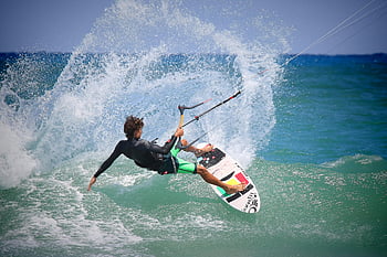 kiteboarding, ocean waves, sunny day, thrilling maneuvers, kiteboarder, surf board, water sports, action sports, outdoor activities, extreme sports, kite surfing