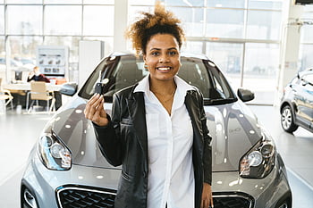 smiling woman, new car, car keys, dealership showroom, car purchase, celebrating, brand new car, showroom, car buying, vehicle purchase, automotive sales