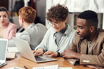 team meeting, diverse professionals, modern office, working on laptops, group collaboration, business people, office setting, professional meeting, team discussion, workplace collaboration, laptop work