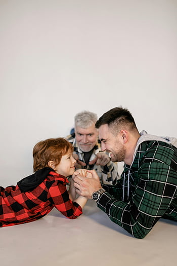 family-arm-wrestling-young-boy-father-grandfather-family-bonding-togetherness-fun-plaid-shirts-indoor-thumbnail.jpg