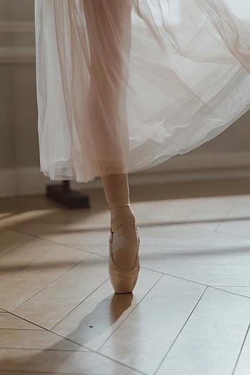 ballet dancer, pink tutu, tip toeing, pointe shoes, soft flowing tutu, indoor ballet, graceful balance, ballerina, ballet performance, dance photography, ballet artistry