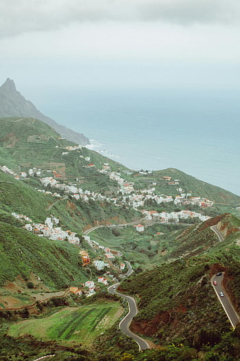 Tenerife, mountain landscape, mountain village, lush green hills, ocean view, Santa Cruz de Tenerife, Spain, coastal scenery, winding roads, scenic route, natural beauty