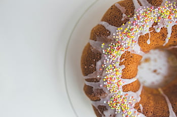 Easter cake, colorful topping, Bundt cake, icing, colorful sprinkles, celebrations, close-up, festive dessert, sweet treat, holiday cake, decorative cake