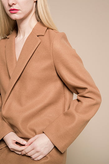 stylish woman, beige coat, trendy fashion, elegant pose, simple background, hands together, fashionable style, beige color, elegant woman, modern fashion, stylish outfit