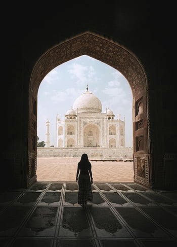 Taj Mahal, woman silhouette, iconic arch, tourist view, daylight scene, majestic architecture, India landmark, travel photography, cultural heritage, Agra, tourist attraction