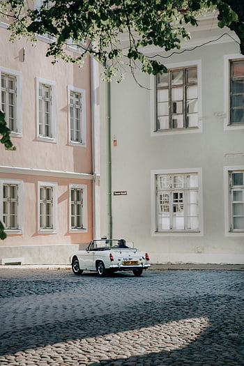 cabriolet vintage blanc, rue de la ville, rue pavée ensoleillée, Tallinn Estonie, voiture classique, voiture garée, scène urbaine, architecture européenne, Photographie de rue, véhicule d'époque, voiture décapotable