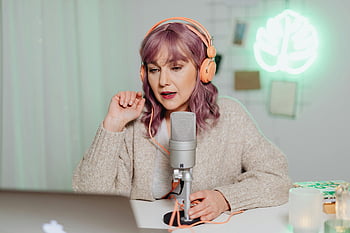 woman podcaster, microphone, headphones, cozy room, speaking, recording, podcast, home studio, neon light, casual outfit, laptop