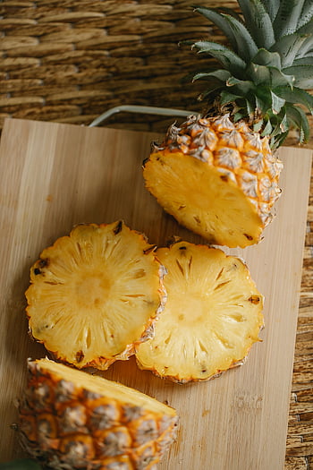 pineapple slices, wooden cutting board, ripe pineapple, tropical flavor, close-up, freshness, pineapple, cutting board, tropical fruit, pineapple slices on board, pineapple slices close-up