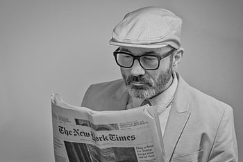 man reading newspaper, The New York Times, man in suit, glasses, cap, black and white, reading, newspaper, man, suit