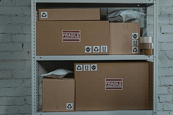 brown cardboard boxes, gray steel rack, fragile boxes, metal shelving, storage room, labeled boxes, handle with care, stacked boxes, storage shelves, cardboard packaging, fragile items