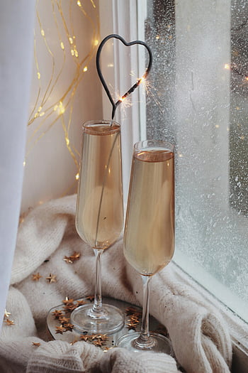 still life, heart-shaped sparkler, champagne flutes, cozy winter, celebration, frosty window, festive, romantic, holiday, indoor, lighting
