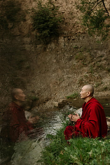 monk meditating, yoga position, grass, tranquil river, Buddhist monk, serene view, reflecting prayer, meditation, nature, outdoor, spirituality