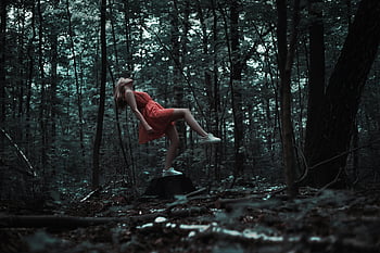 woman levitating, red dress, mysterious forest, magic, creativity, brown tree trunk, forest setting, levitation, surreal, nature, mystery