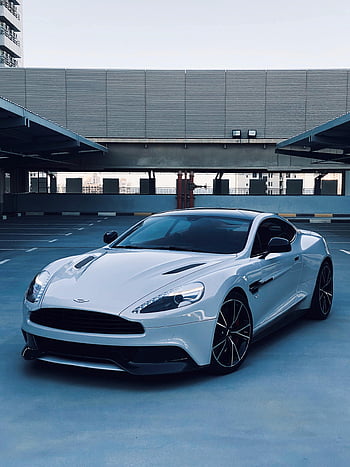 Aston Martin Vanquish, Carbon, sleek, white, modern urban, parking area, luxury car, sports car, high-end vehicle, automotive design, cityscape backdrop