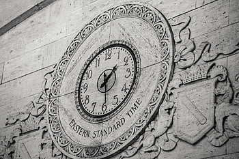 aged brick, antique clock, Roman numerals, decorative stone wall, coat of arms, Eastern Standard Time, detailed view, stone wall clock, vintage clock, architectural detail, wall clock design