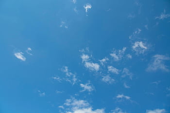 blue sky, fluffy clouds, bright blue, serene atmosphere, scattered clouds, white clouds, clear sky, peaceful sky, sky background, cloud pattern, natural sky