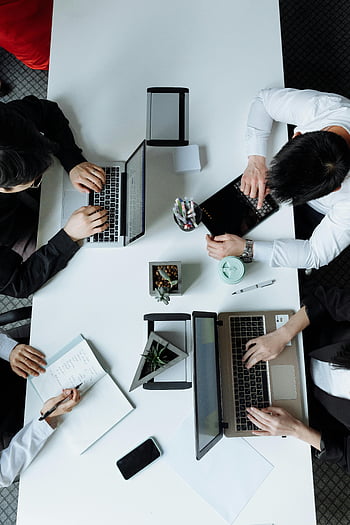 overhead shot, group meeting, diverse team, modern office, laptops, collaboration, work environment, professional setting, team work, office workspace, business meeting