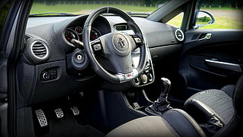 black car steering wheel, modern car interior, dashboard view, car interior details, steering wheel close-up, dashboard controls, car dashboard, interior design, car interior features, modern dashboard, car steering wheel