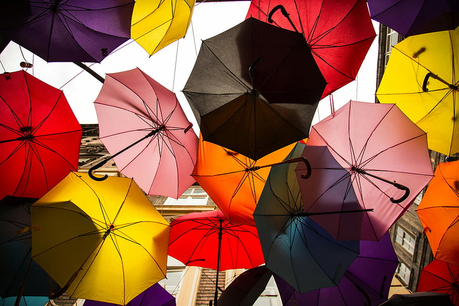 colorful umbrellas, art installation, vibrant outdoor canopy, multi-colored umbrella roof, low angle photo, hanging umbrellas, outdoor art, colorful canopy, umbrella art, vibrant umbrellas, outdoor umbrellas
