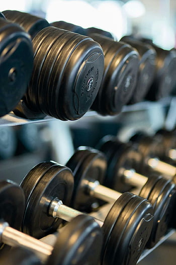 black dumbbells, gym equipment, weight training, fitness center, workout tools, exercise gear, strength training, gym dumbbells, fitness gym, weight lifting, gym rack