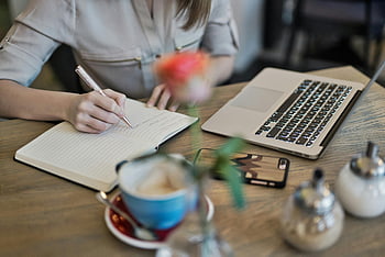 woman writing, notebook, Macbook, coffee cup, desk, workspace inspiration, laptop, workspace, productivity, office setting, creative work
