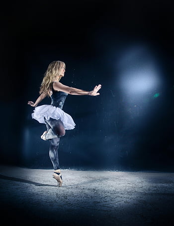 woman dancing, ballet dancer, graceful pose, dimly lit stage, elegant dance, movement, poise, stage performance, ballet tutu, spotlight, artistic dance