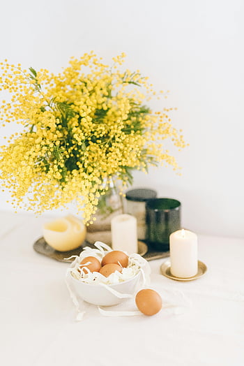 Easter table setup, yellow mimosa flowers, lighted candles, brown eggs, elegant Easter decor, table arrangement, spring decoration, Easter decoration, yellow flowers, candles