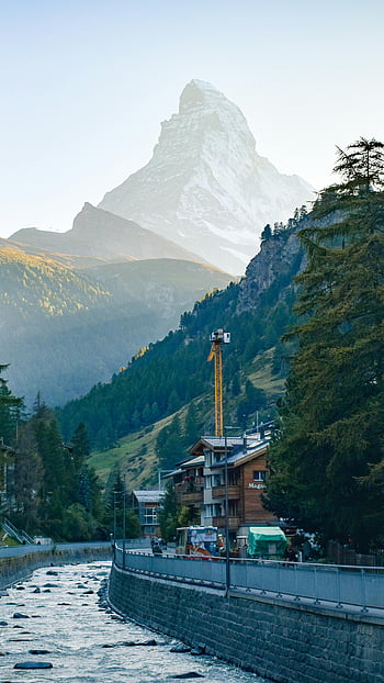 Matterhorn, Zermatt, Switzerland, alpine setting, picturesque view, mountain, snow-capped peak, Swiss Alps, village, crane, river