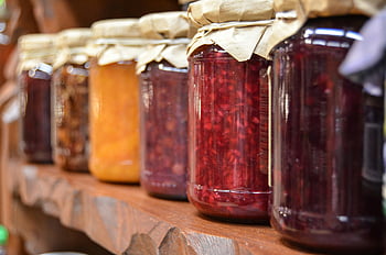 clear glass mason jars, homemade jam jars, wooden shelf, close-up view, various jams, glass jars, homemade preserves, mason jars, jam containers, rustic shelf, food storage