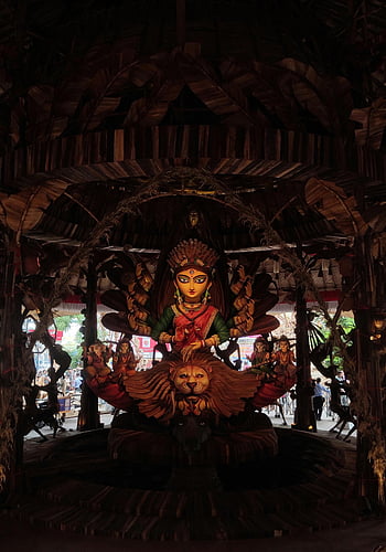 Goddess Durga, Hindu deity, Kolkata Durga Puja, traditional festival, intricate idol, lion statue, cultural event, Indian festival, religious statue, temple decoration, festival celebration